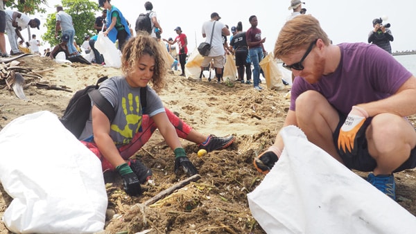 beach cleaning and snorkel activities in jamaica - cleaning beach